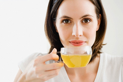 Woman drinking green tea --- Image by © Image Source/Corbis